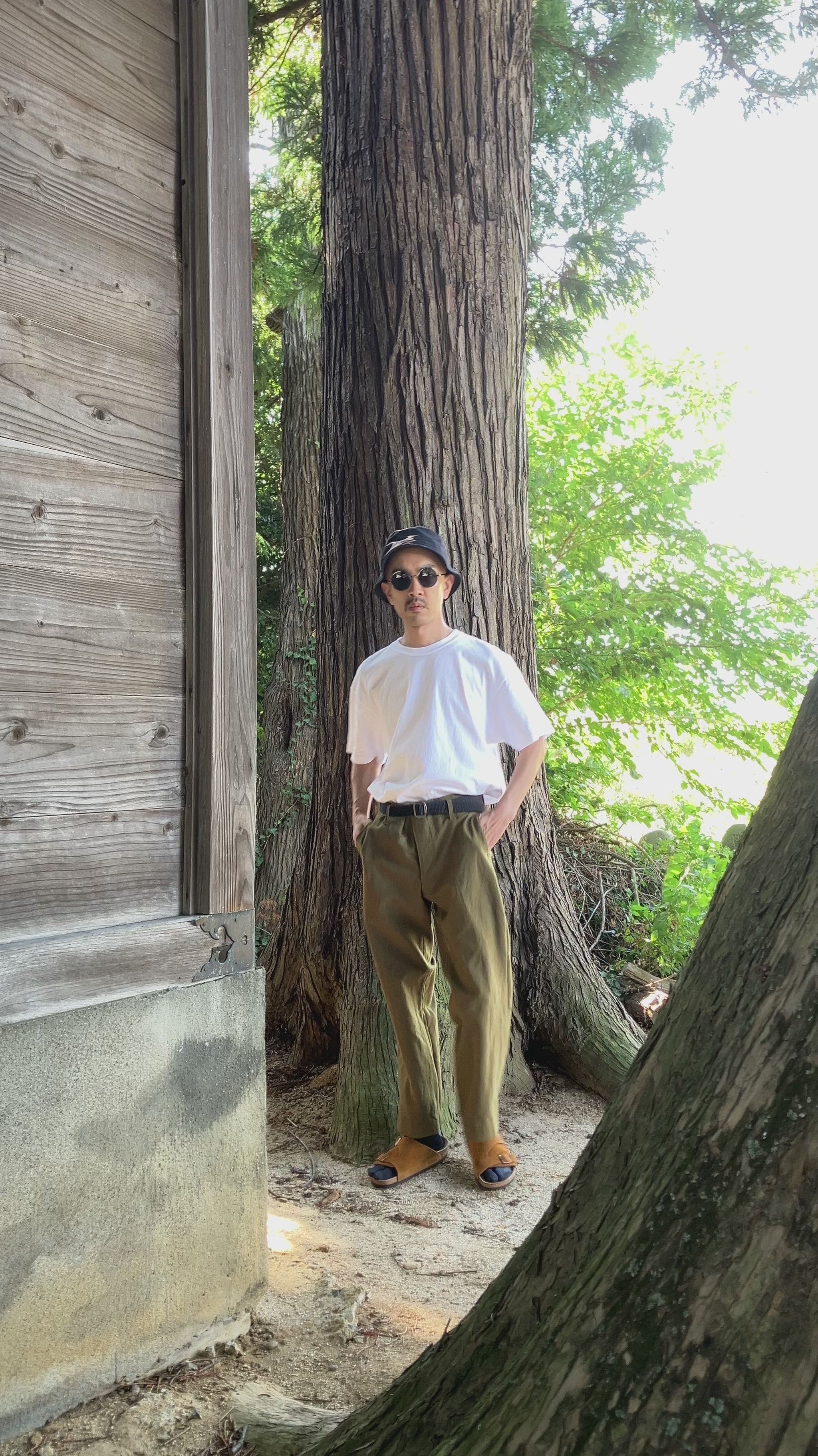 Model wearing vintage Japanese straight-leg wool trousers with T-shirt and sandals