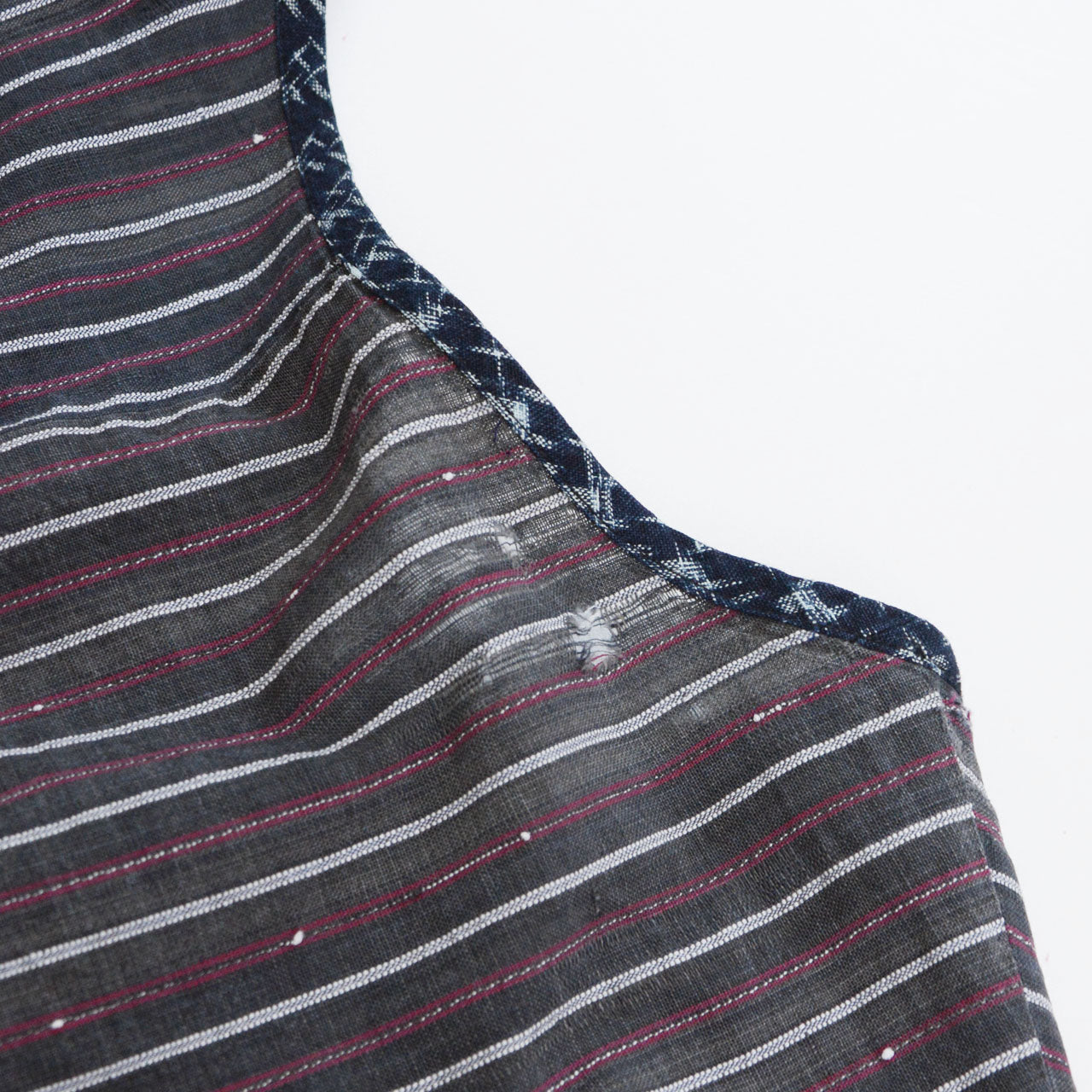 Indigo kasuri neckline trim detail and thinning area on Showa-era stripe cotton tunic, vintage Japanese remake