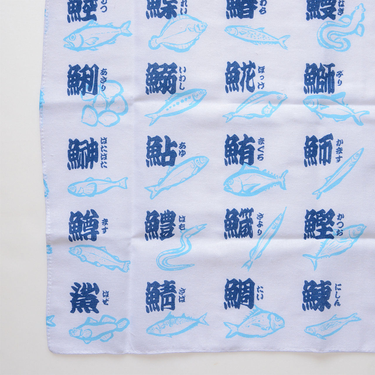 Traditional Japanese tenugui featuring fish illustrations and kanji
