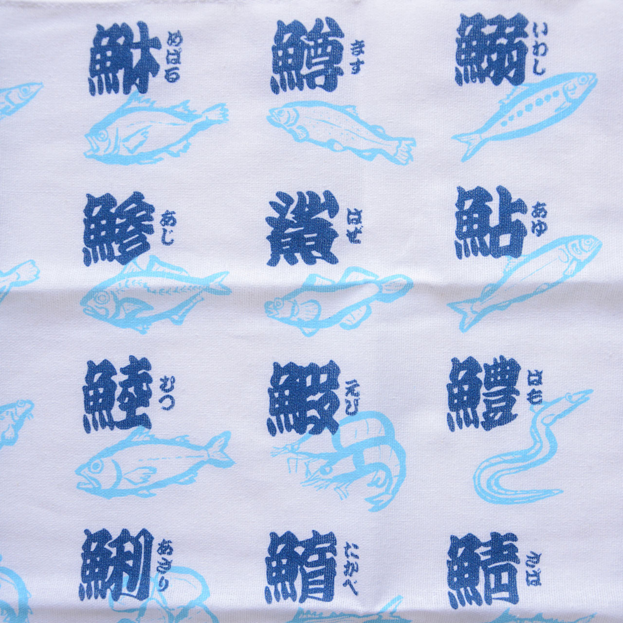 Japanese cultural tenugui towel showcasing fish kanji calligraphy