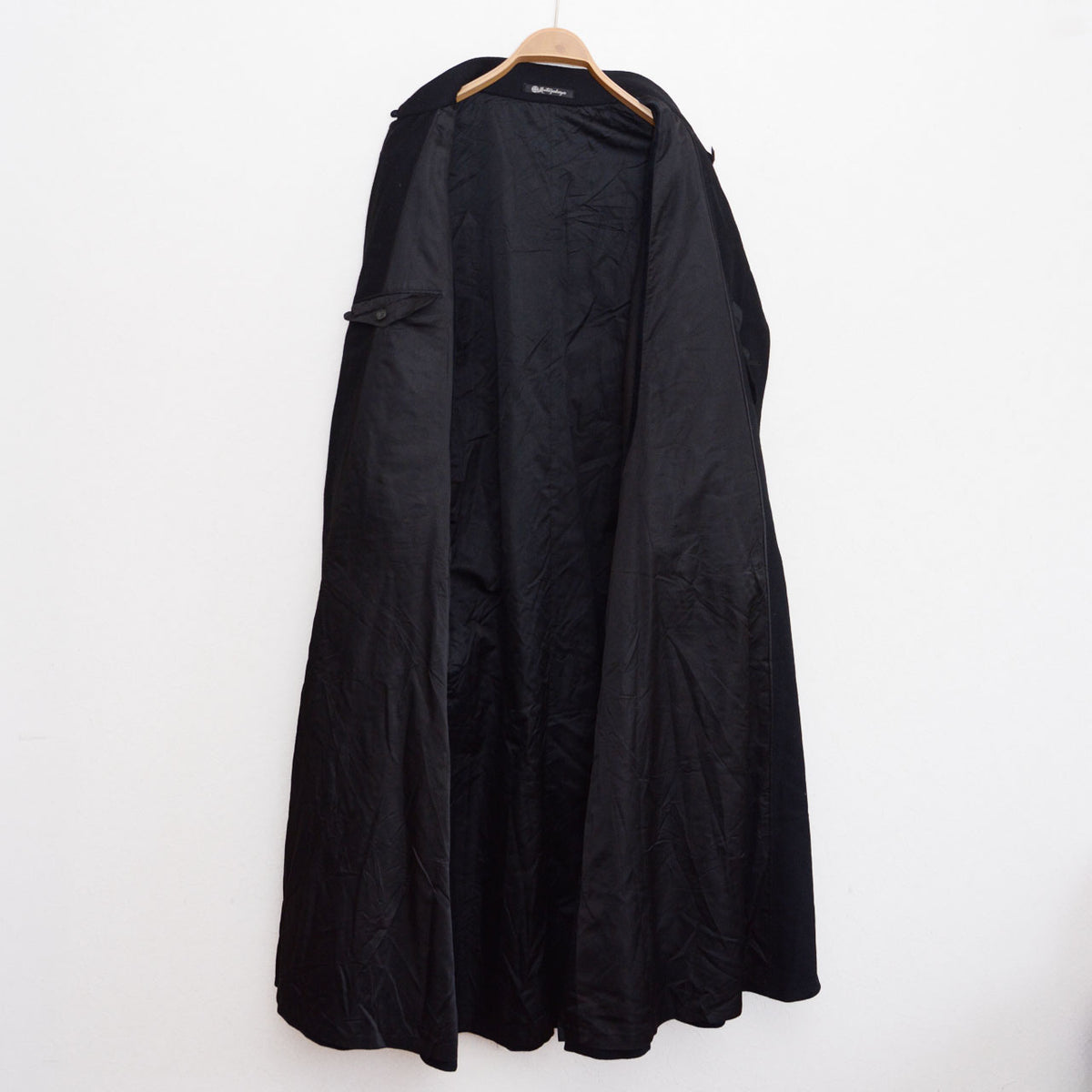 Black lining and neck label of a Matsuzakaya wool tonbi coat, early Showa Japanese vintage