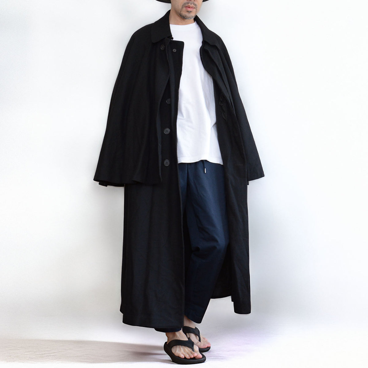 Matsuzakaya black wool tonbi coat with a layered cape and long button-front body, early Showa Japanese vintage