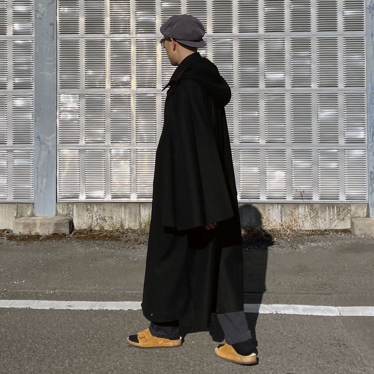 Full-length side view, model wearing black wool tonbi mantle, Inverness-style double cape, Japan vintage