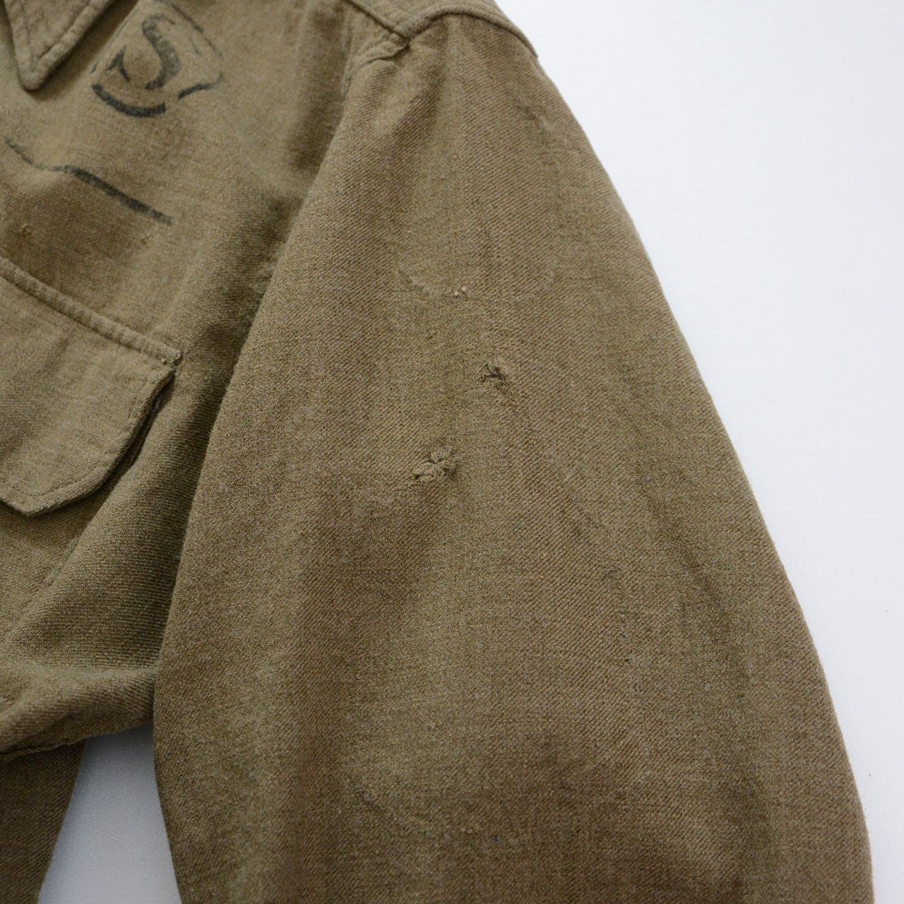 Front pocket stencil detail on vintage military shirt
