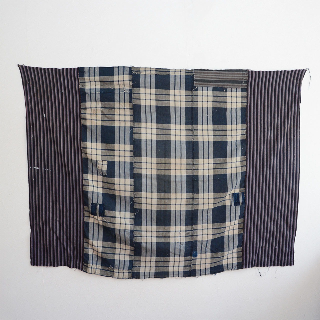 Close-up of aged indigo cotton texture with visible stitching and fading