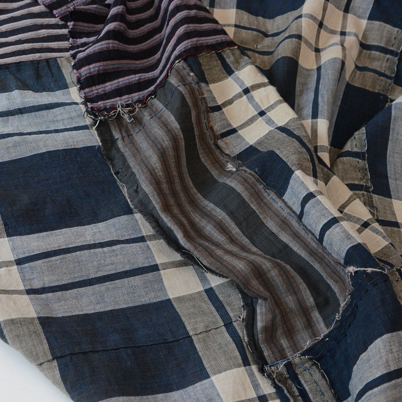 Natural wear, small holes, and patch marks add character to the vintage textile