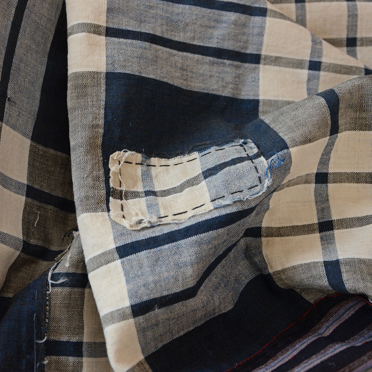 Detailed view of hand-sewn seams on old Japanese indigo cotton