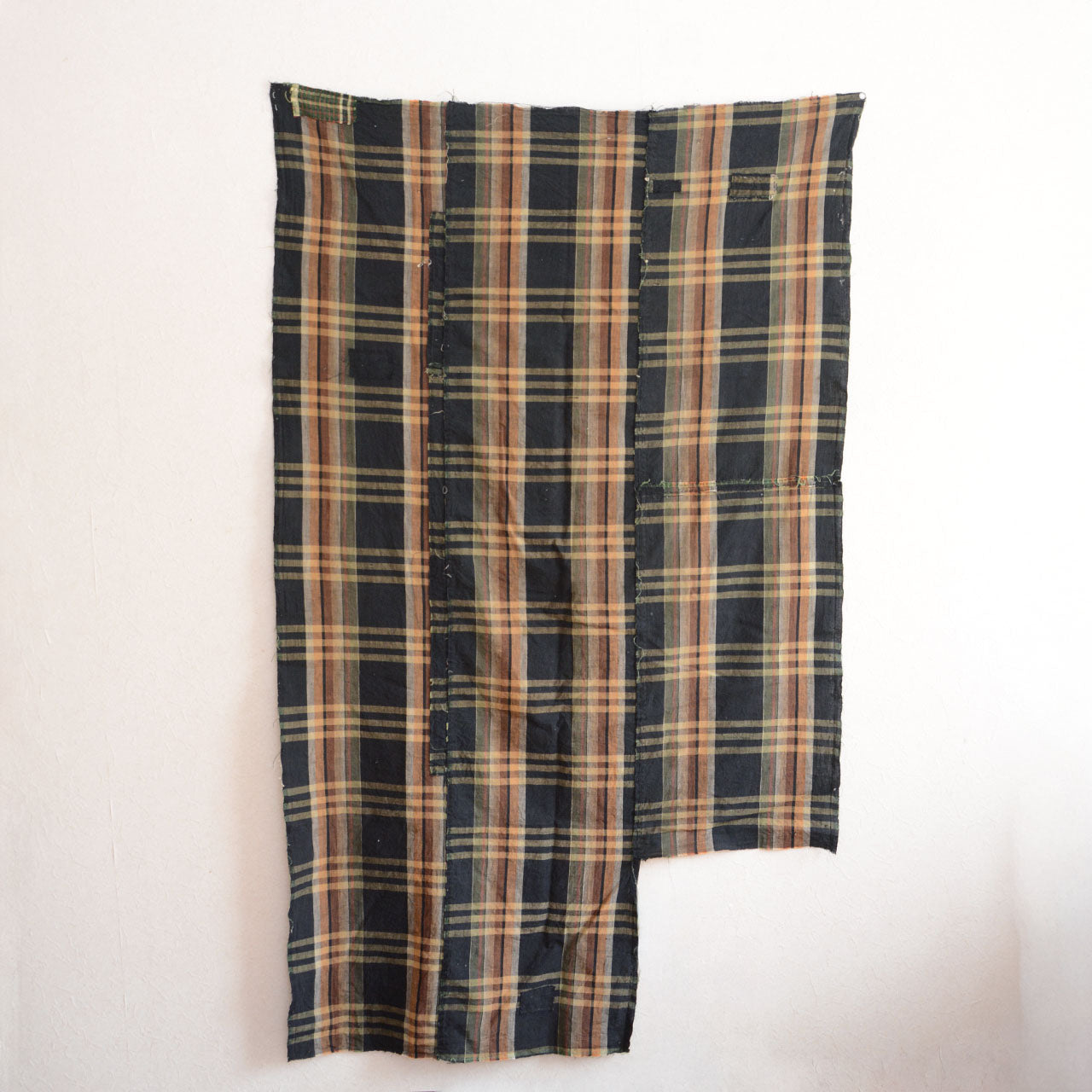 Japanese Boro textile with soft cotton texture and subtle black-check pattern.