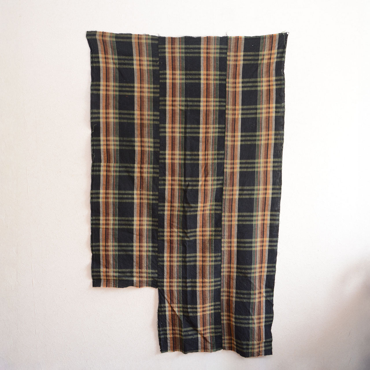 One-of-a-kind black-check Boro fabric with visible patches and wear.