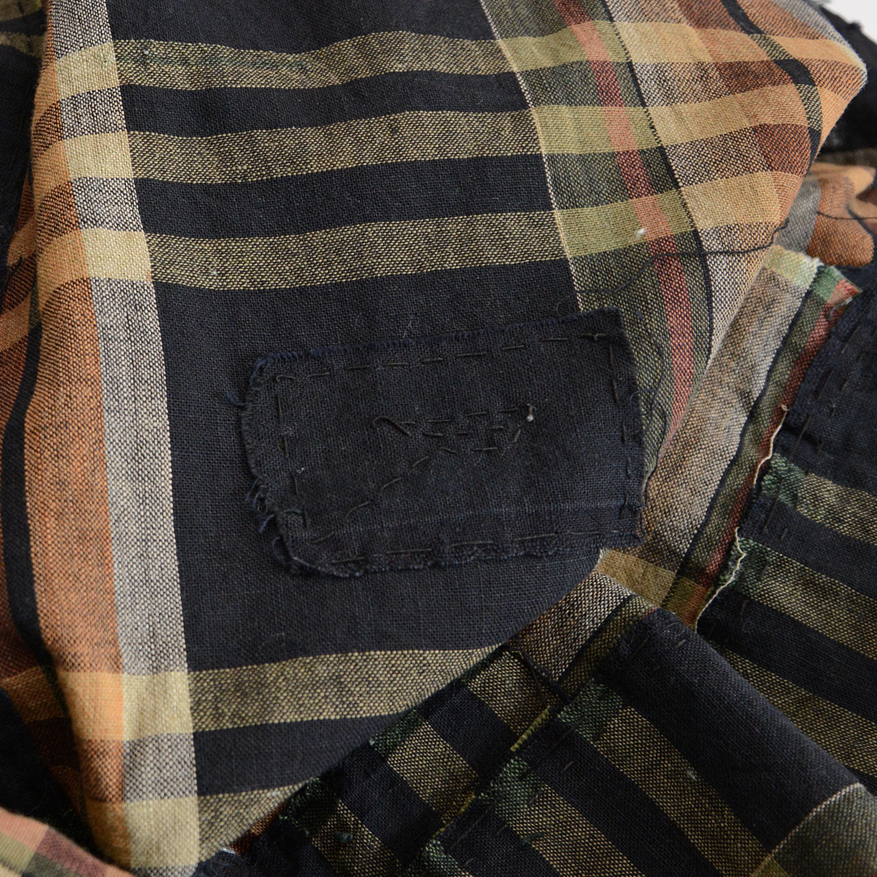 Aged Japanese Boro textile with deep black-check tones and subtle repairs.