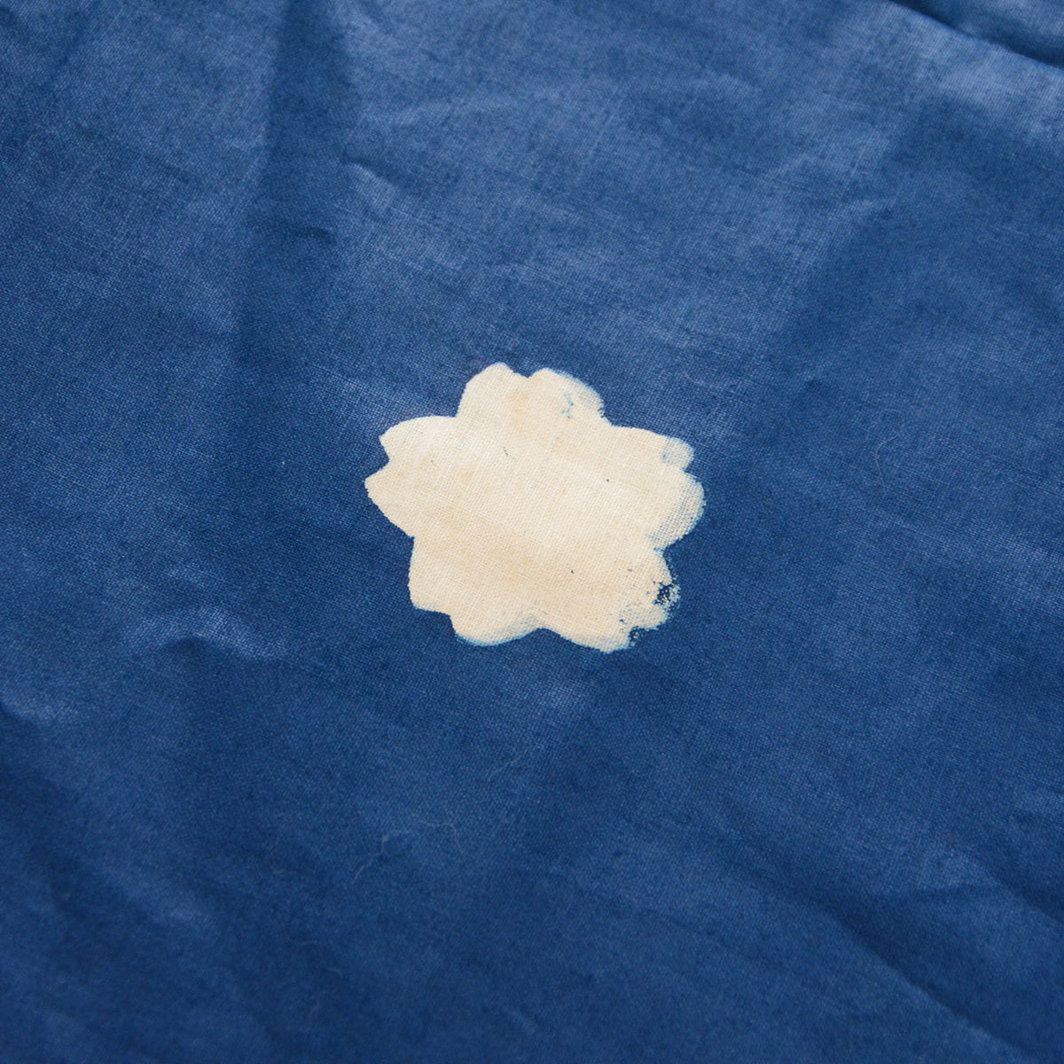 Blue cotton furoshiki with an ivory cherry blossom emblem
