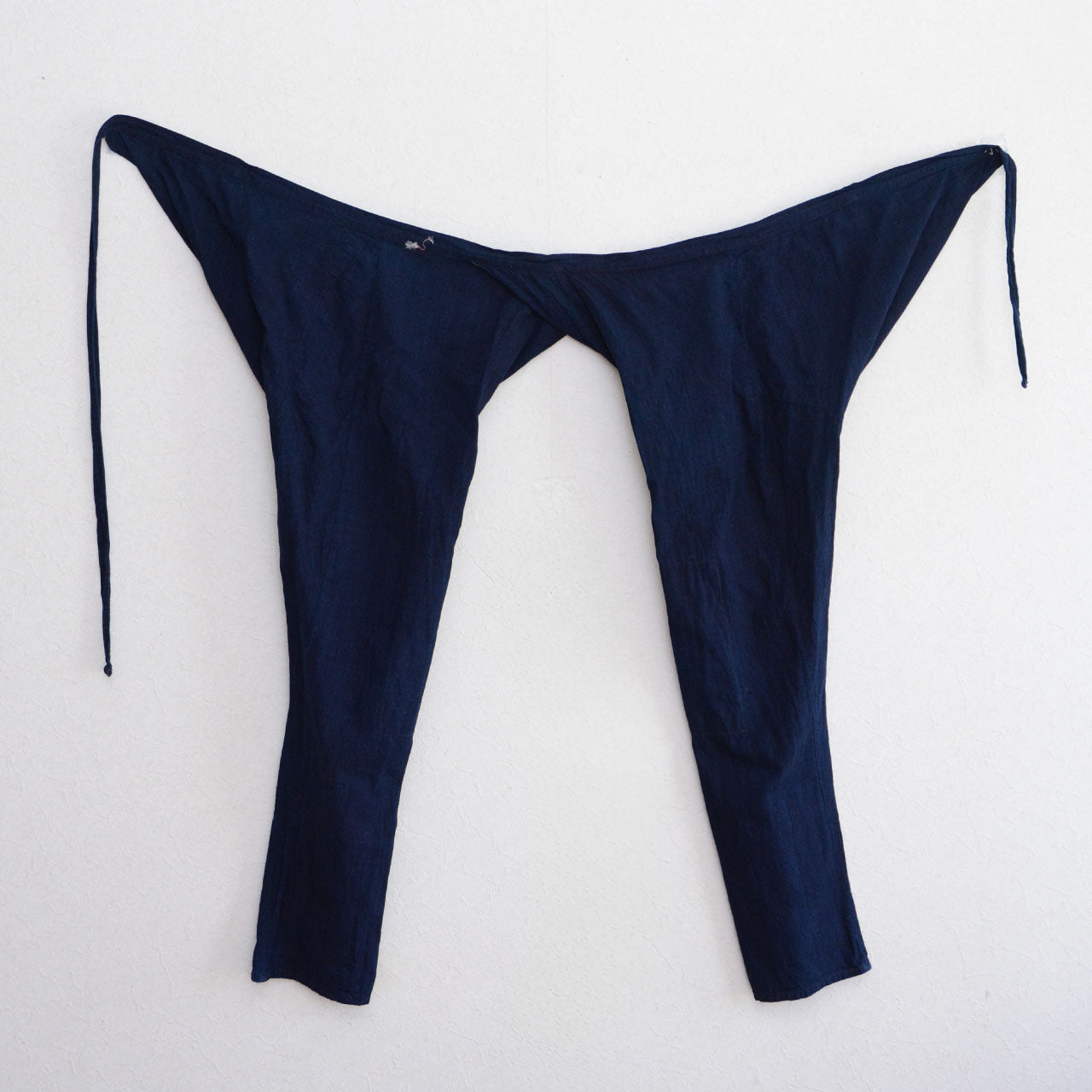 Handmade indigo cotton trousers with a tapered hem