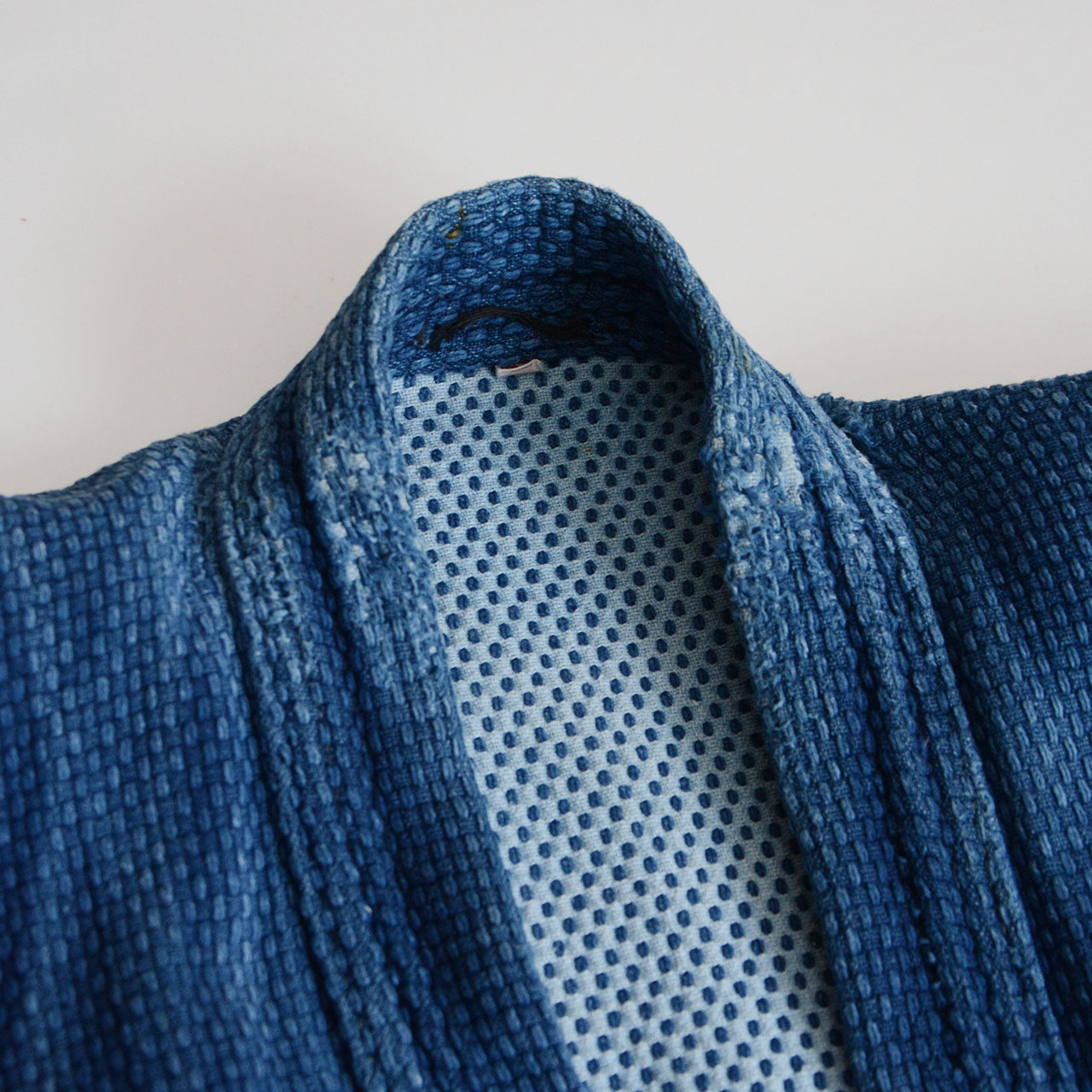 Aged indigo cotton jacket with unique textile presence