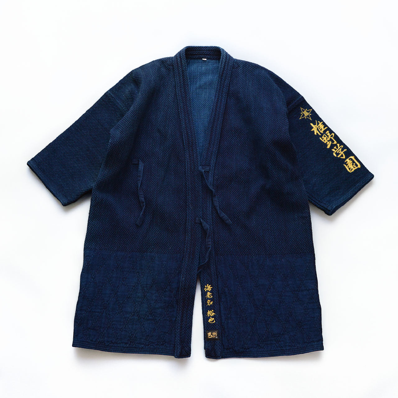 Vintage Japanese kendo gi in deep indigo, double-woven 100% cotton with gold kanji embroidery on the sleeve