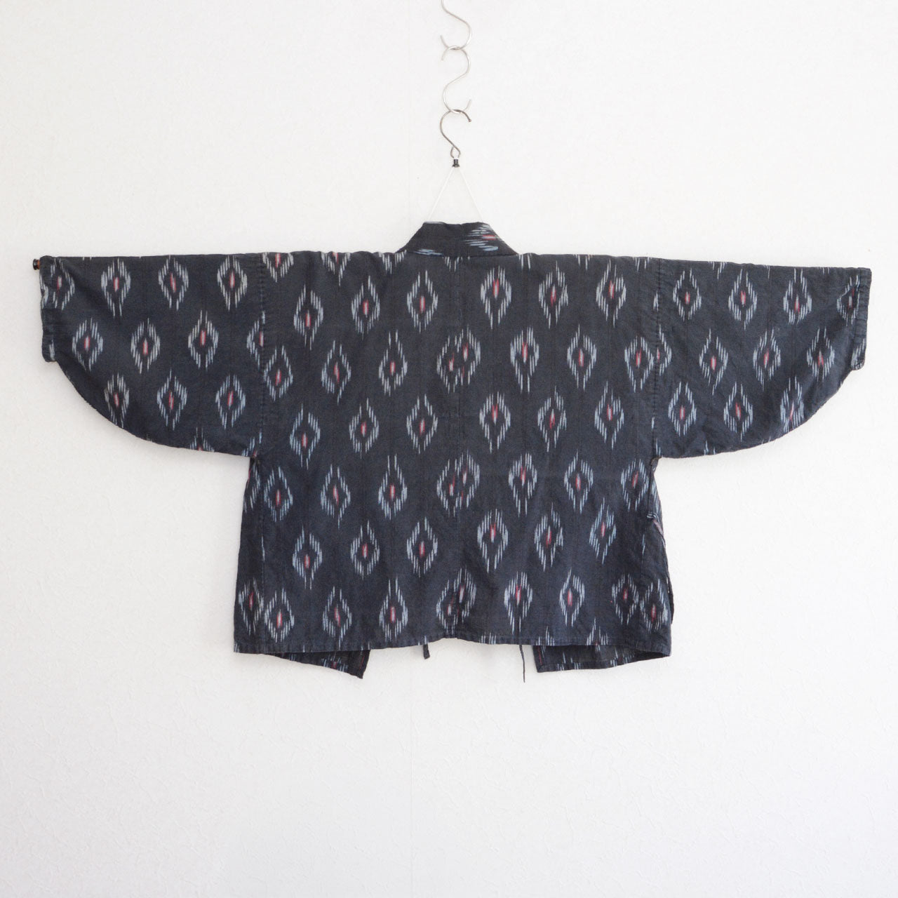 Mid-Showa era Japanese noragi jacket, black faded cotton, eye-like kasuri pattern, slow fashion