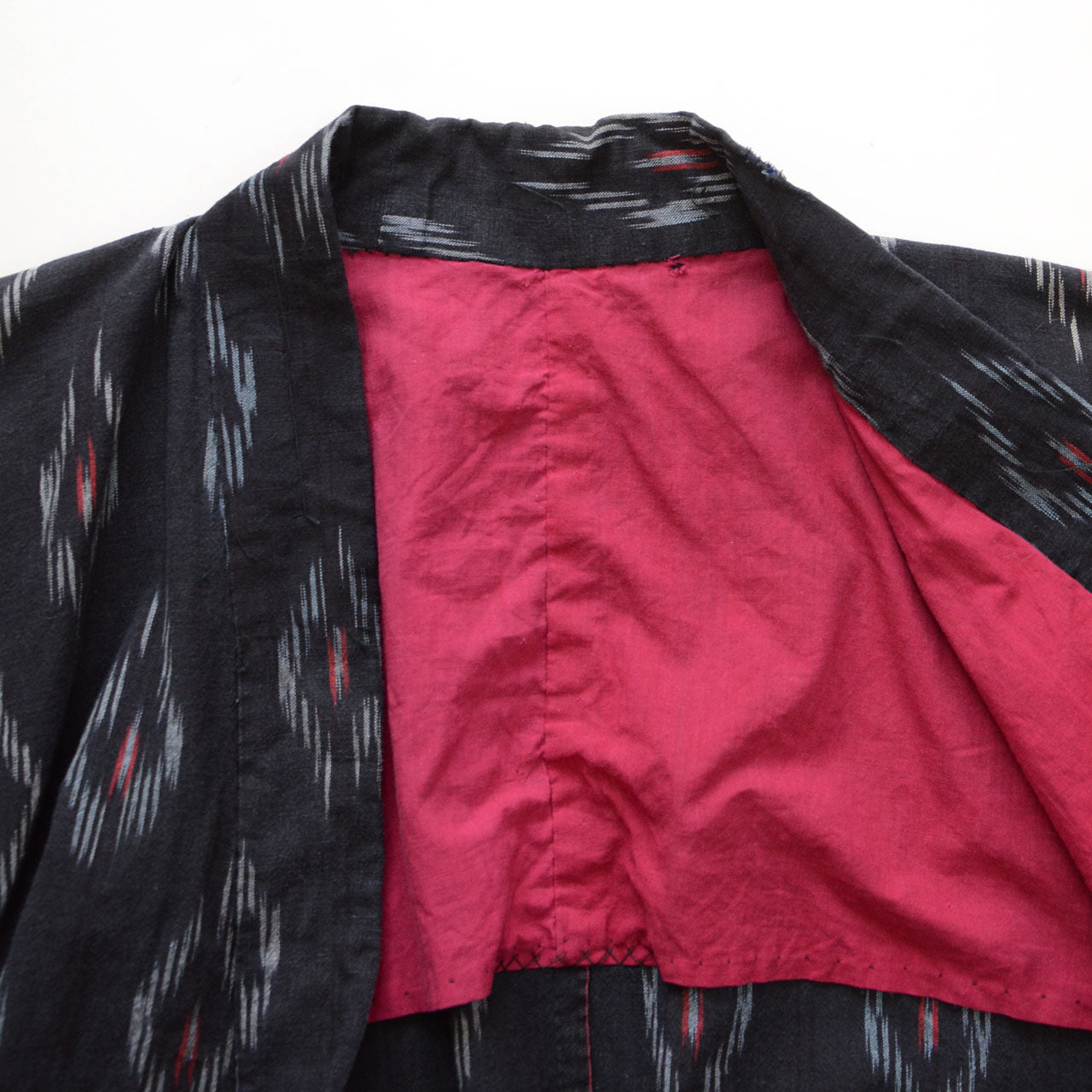 Vintage Japanese noragi, black cotton with kasuri ikat, maroon lining, Showa period workwear