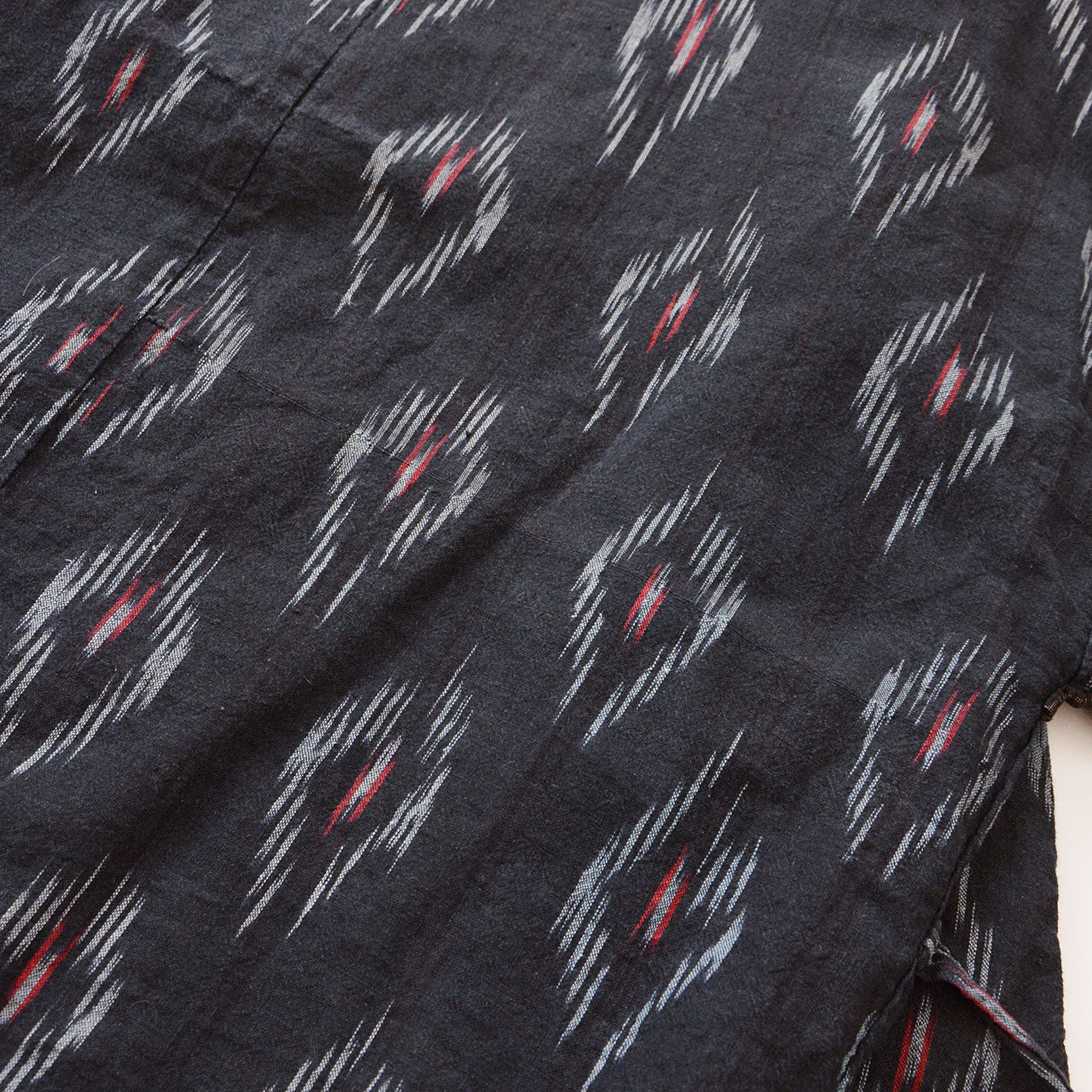 Faded black cotton noragi, kasuri ikat pattern, maroon lining, Japanese vintage workwear