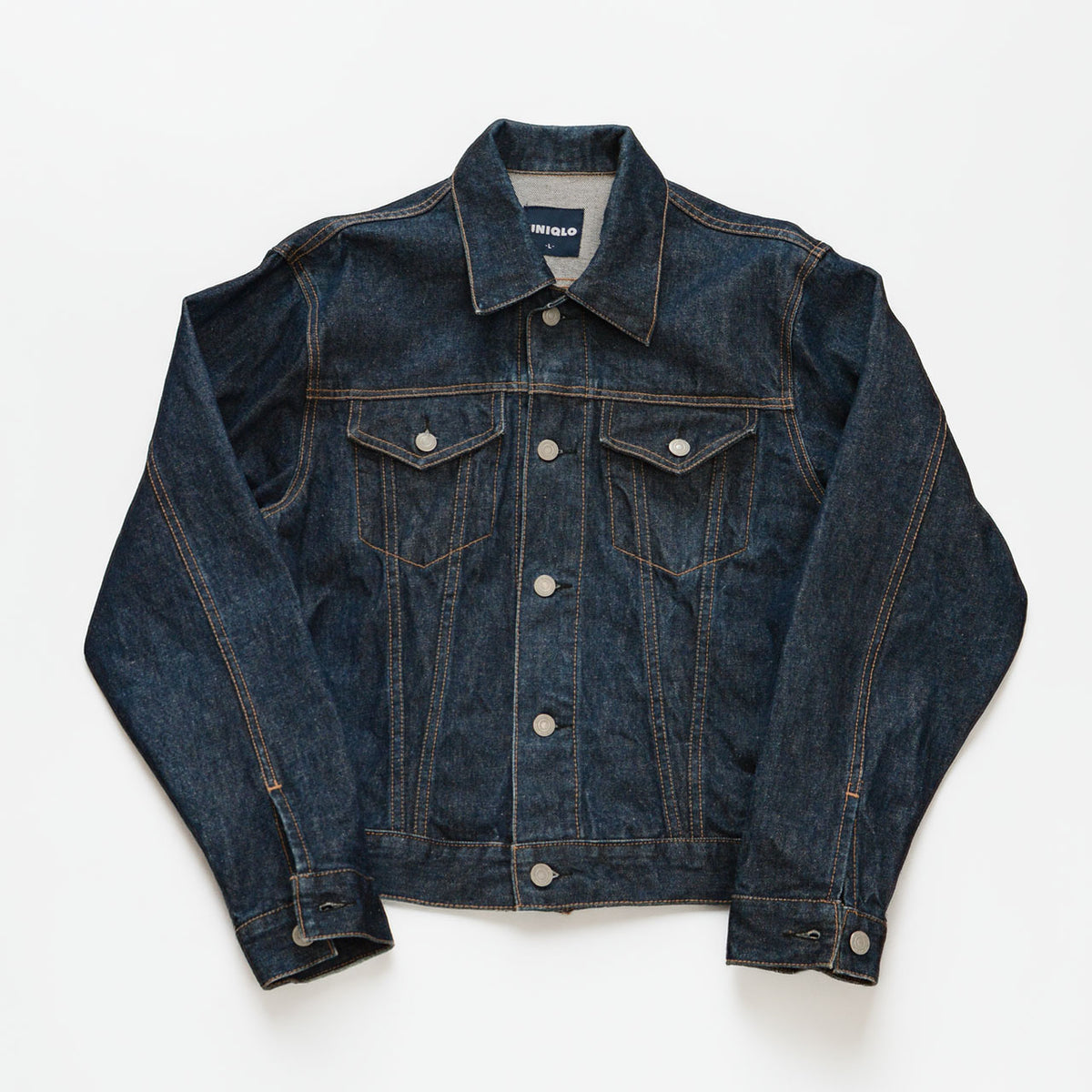 Vintage UNIQLO dark indigo cotton denim trucker jacket with flapped chest pockets