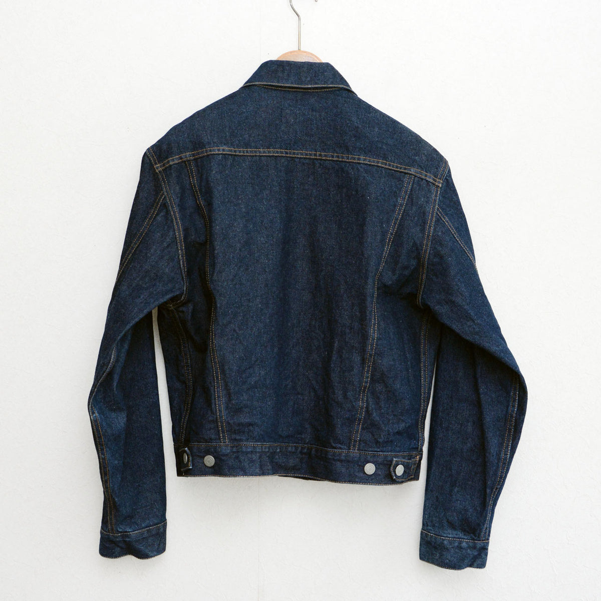 UNIQLO indigo denim jacket with rear yoke seams and waist adjustment tabs