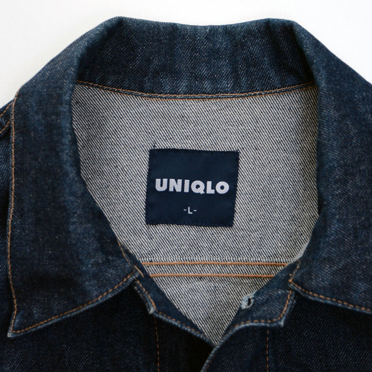 Dark UNIQLO label with white lettering and size L