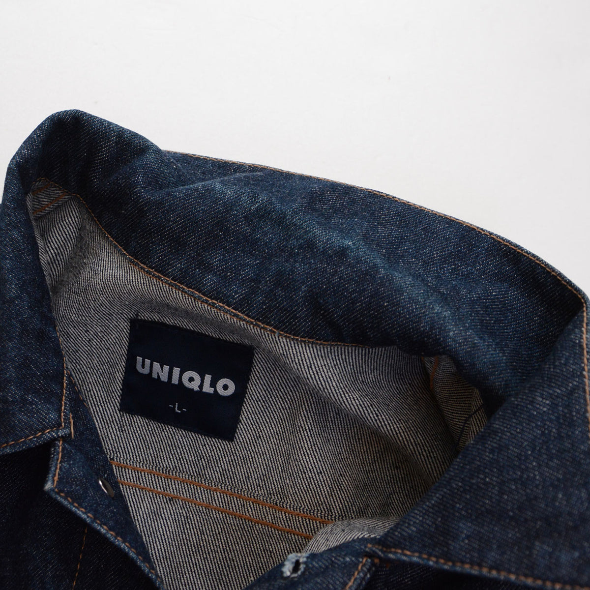 Vintage UNIQLO denim jacket collar with partial indigo fading
