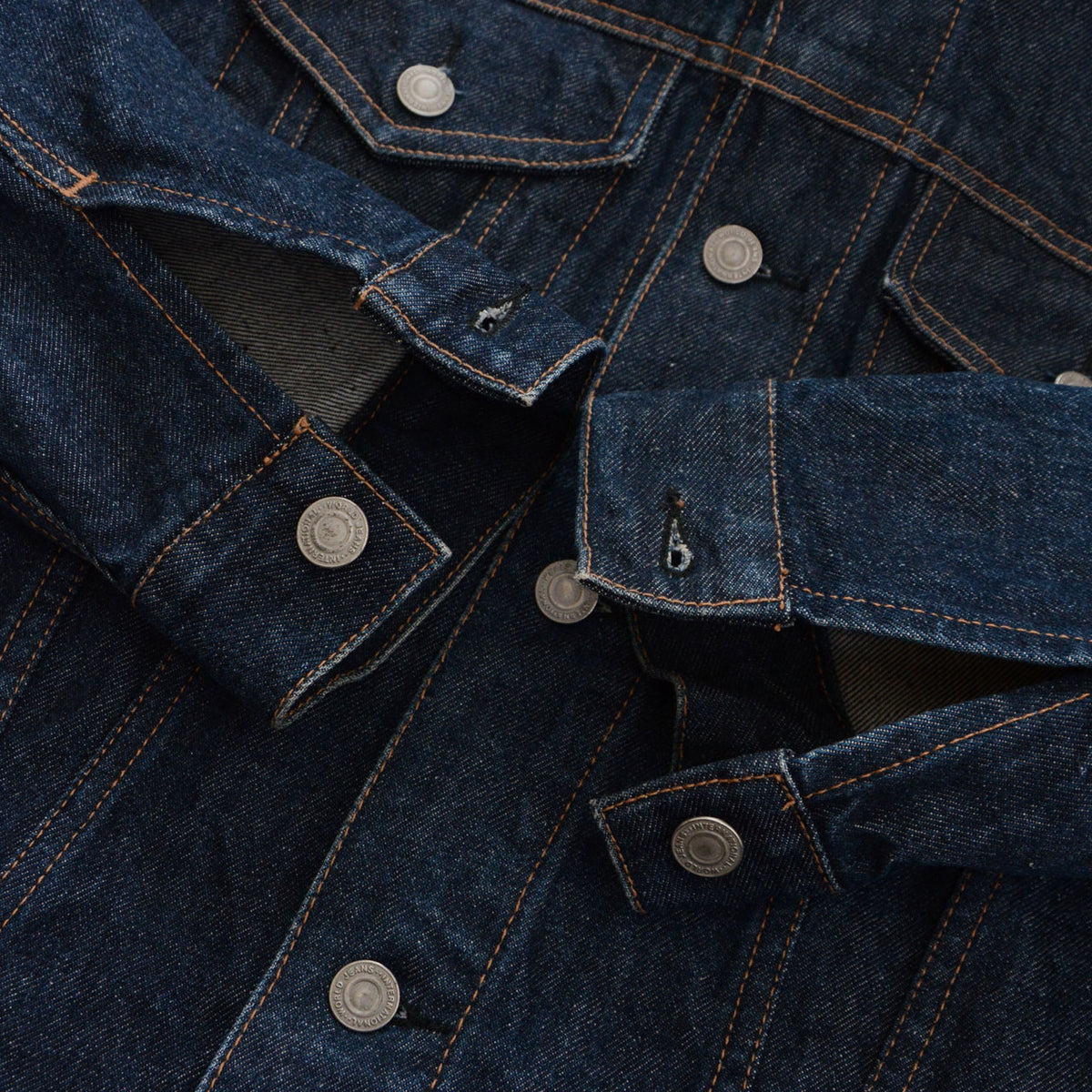 UNIQLO dark indigo denim jacket cuffs with metal button fastenings